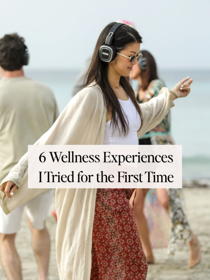 Lin on a beach wearing headphones, with the words: 6 wellness experiences I tried for the first time